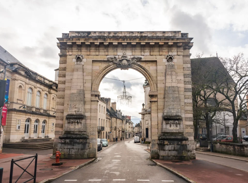 Beaune, France - January 8 2023 - People passing the Porte Saint-Nicolas