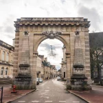 Beaune, France - January 8 2023 - People passing the Porte Saint-Nicolas