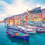 Mystic landscape of the harbor with colorful houses and the boats in Porto Venero, Italy, Liguria in the evening in the light of lanterns