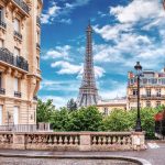 Small Paris street with view on the famous Eiffel Tower in Paris, France.