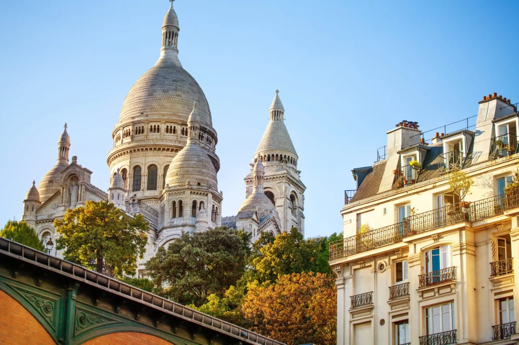 Sacre Coeur cathedral over classical Paris house