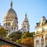 Sacre Coeur cathedral over classical Paris house