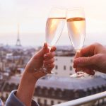 two glasses of champagne or wine, couple in Paris, romantic celebration of engagement or anniversary